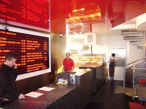 The ground floor takeaway counter at Tom's Place, with electronic catch of the day board